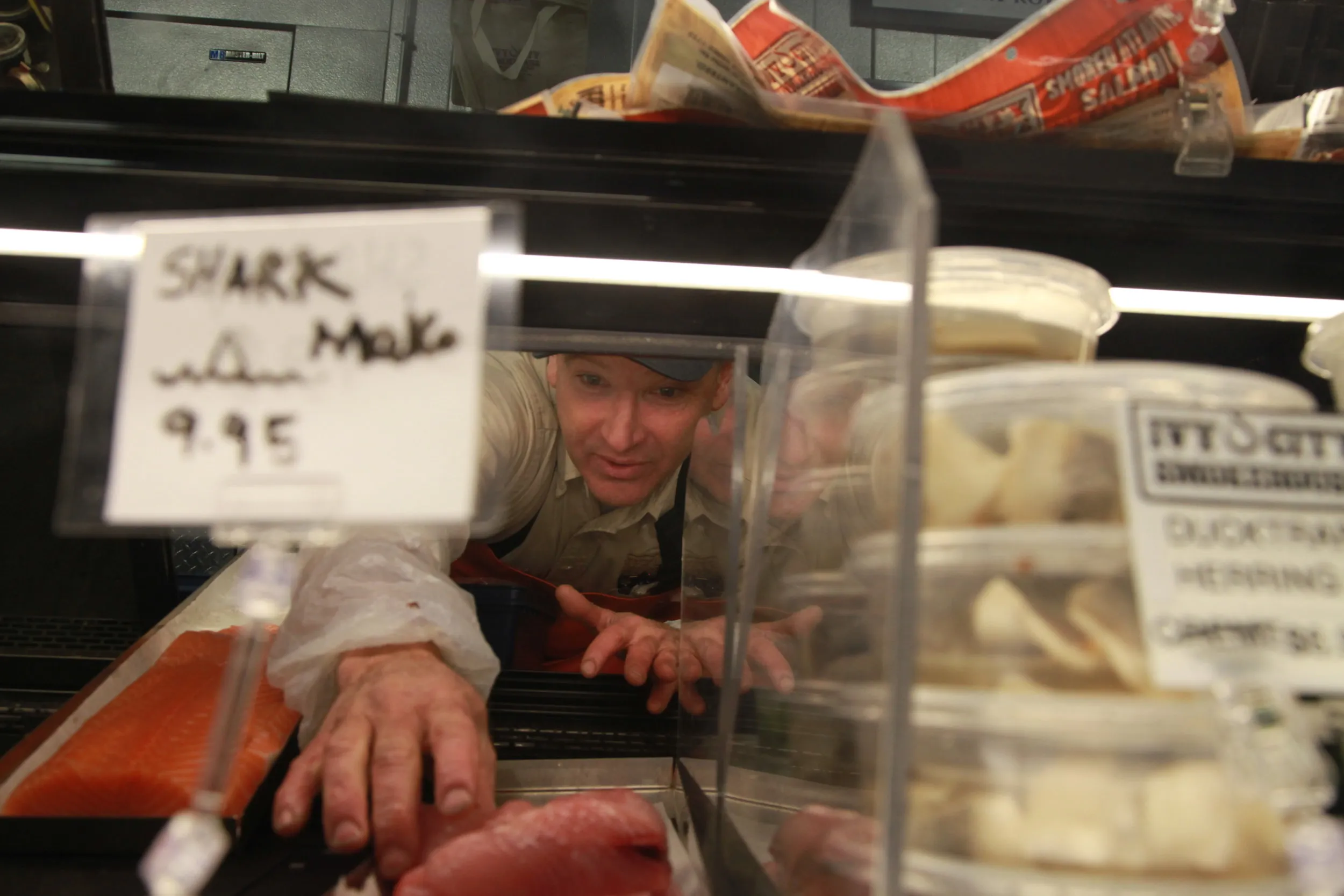 Fishmonger Peter Martone is arranging the display of seafood in Ivy City Smokehouse in Washington, D.C., on Dec. 7, 2016. Martone has experience in purchasing, handling and selling seafood for more than 30 years.